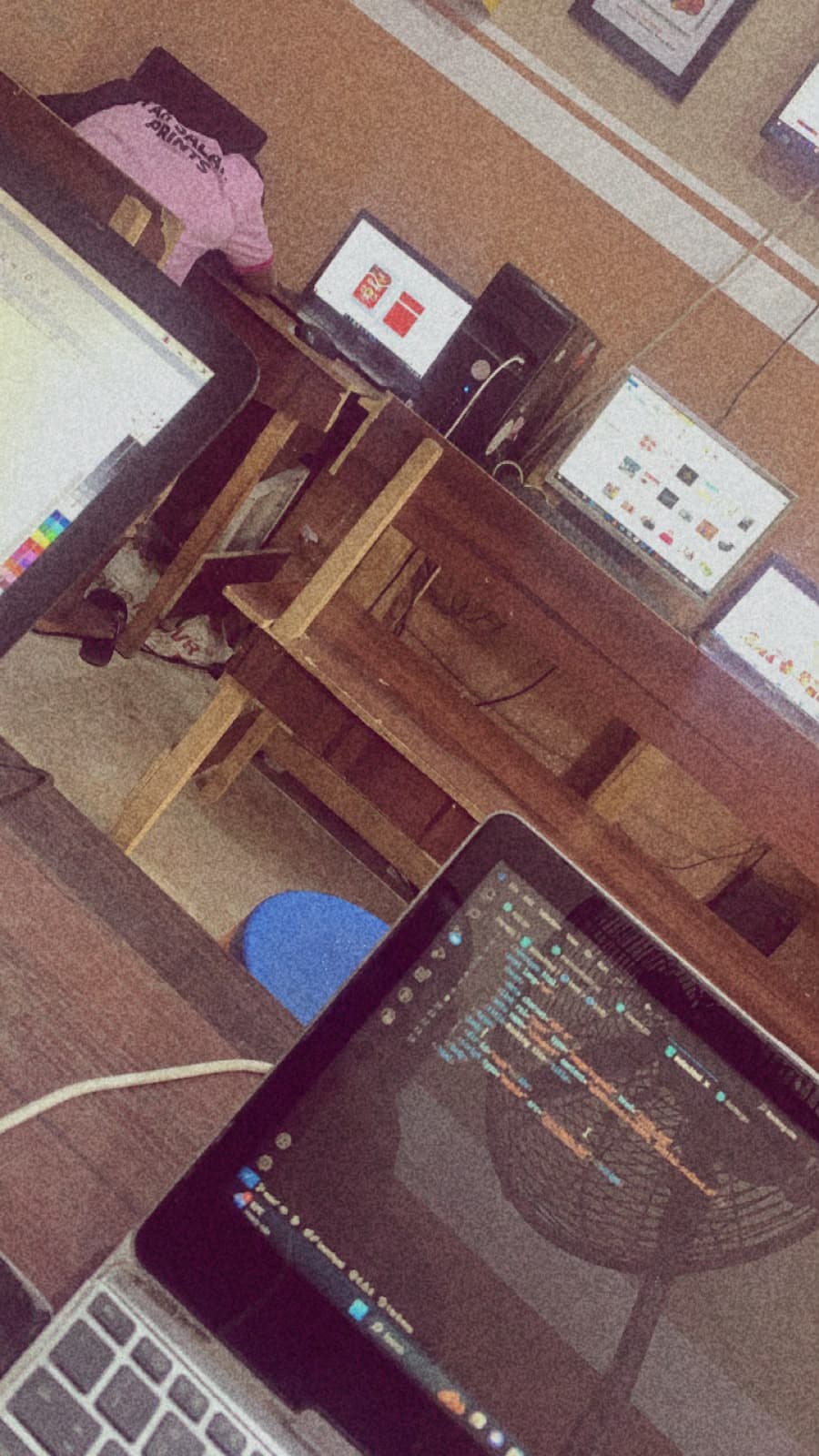 A shared training space with monitors and a laptop showing code