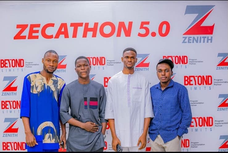 Olatunji and his three teammates in front of the Zecathon 5.0 backdrop